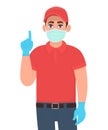 Delivery man or courier in safety medical mask, gloves pointing finger up. Person showing or gesturing hand sign. Door delivery