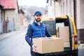 Delivery man delivering parcel box to recipient. Royalty Free Stock Photo