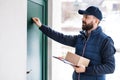 Delivery man delivering parcel box to recipient. Royalty Free Stock Photo