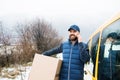 Delivery man delivering parcel box to recipient. Royalty Free Stock Photo