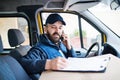 Delivery man delivering parcel box to recipient. Royalty Free Stock Photo