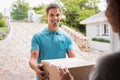 Delivery man delivering parcel Royalty Free Stock Photo