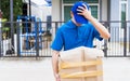 Delivery man he emotional courier hold damaged cardboard box is broken Royalty Free Stock Photo