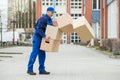 Delivery Man With Falling Stack Of Boxes