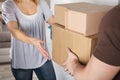 Delivery Man Giving Parcel Box To Young Woman Royalty Free Stock Photo