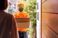 Delivery man handling cardboard box send to customer woman at home Royalty Free Stock Photo