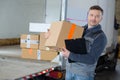 Delivery man holding box in front truck Royalty Free Stock Photo