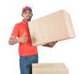 Delivery man holding carton boxes and thumb up in uniform Royalty Free Stock Photo