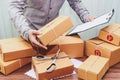 Delivery man holding clipboard and cardboard box for for delivery Royalty Free Stock Photo