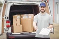 Delivery man holding clipboard Royalty Free Stock Photo