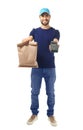 Delivery man holding paper bag with food and payment terminal on white background Royalty Free Stock Photo