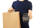 Delivery man holding paper bag with food and payment terminal on white background Royalty Free Stock Photo