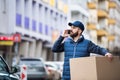 Delivery man with a parcel box on the street. Royalty Free Stock Photo