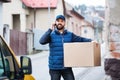 Delivery man with a parcel box on the street. Royalty Free Stock Photo