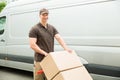 Delivery Man Holding Trolley With Cardboard Boxes Royalty Free Stock Photo