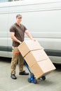 Delivery Man Holding Trolley With Cardboard Boxes Royalty Free Stock Photo