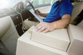 Delivery man inside the car checking list on clipboard Royalty Free Stock Photo