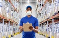 Delivery man in mask or respirator at warehouse Royalty Free Stock Photo