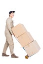 Delivery man moving luggage trolley with cardboard boxes Royalty Free Stock Photo