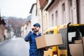 Delivery man with a parcel box on the street. Royalty Free Stock Photo