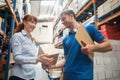 Delivery man passing parcel to warehouse manager Royalty Free Stock Photo