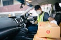 A delivery man is picking up a box in a friend`s car to deliver it to a customer, Select focus a box