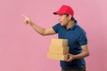 Delivery man pointing a copy space with holding parcel post box Royalty Free Stock Photo