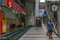 Delivery man pushes a trolley at Silom street next to Saladaeng Bts Station in Bangkok, Thailand.