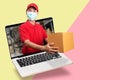 Delivery man in red shirt with hygienic mask, holding goods order in package parcel out from laptop computer with warehouse Royalty Free Stock Photo