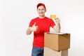 Delivery man in red uniform isolated on white background. Male courier in cap holding credit card, pen, clipboard with Royalty Free Stock Photo