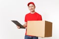 Delivery man in red uniform isolated on white background. Male courier in cap, t-shirt holding pen, clipboard with Royalty Free Stock Photo