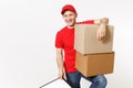 Delivery man in red uniform isolated on white background. Male courier in cap, t-shirt holding pen, clipboard with Royalty Free Stock Photo