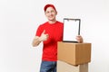 Delivery man in red uniform isolated on white background. Male courier in cap, t-shirt holding pen, clipboard with Royalty Free Stock Photo