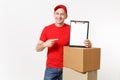 Delivery man in red uniform isolated on white background. Male courier in cap, t-shirt holding pen, clipboard with Royalty Free Stock Photo