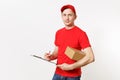 Delivery man in red uniform isolated on white background. Male courier in cap, t-shirt holding pen, clipboard with Royalty Free Stock Photo