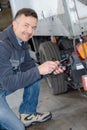 Delivery man setting truck platform for loading