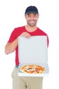 Delivery man showing fresh pizza on white background Royalty Free Stock Photo