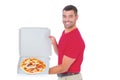 Delivery man showing fresh pizza on white background Royalty Free Stock Photo