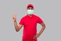 Delivery man Showing Peace Sign Wearing Medical Mask Isolated. Indian Delivery Boy Smilling Peace