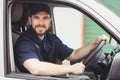 Delivery man sitting in his van Royalty Free Stock Photo