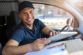 Delivery man sitting in a delivery van Royalty Free Stock Photo