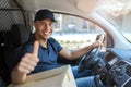 Delivery man sitting in a delivery van Royalty Free Stock Photo