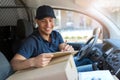 Delivery man sitting in a delivery van Royalty Free Stock Photo