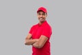 Delivery Man Standing Hands Crossed Smiling. Indian Delivery Boy in Red Uniform Isolated Royalty Free Stock Photo