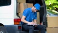 Delivery man stocktaking checklist with amount of parcels, part-time job service Royalty Free Stock Photo