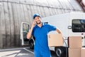Delivery man talking by phone