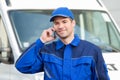 Delivery Man In Uniform Using Mobile Phone Royalty Free Stock Photo