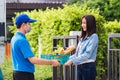 Delivery man wear face mask grocery fast service giving fresh food vegetable to woman customer Royalty Free Stock Photo