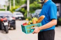 Delivery man wearing face mask protect he delivering fresh food vegetable in plastic box