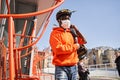 Delivery man wearing protective mask going to his client with bag with parsels